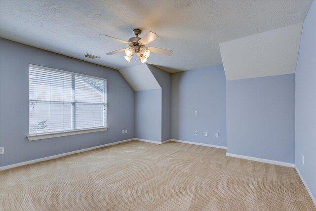 17519 Bighorn River Ln, Humble, TX 77346 - additional living space featuring carpet floors, a textured ceiling, a ceiling fan, baseboards, and lofted ceiling