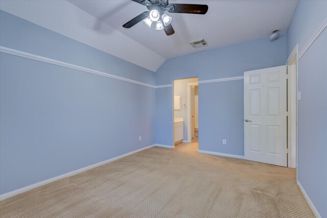 17519 Bighorn River Ln, Humble, TX 77346 - unfurnished bedroom with light colored carpet, baseboards, vaulted ceiling, connected bathroom, and ceiling fan