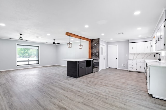 kitchen with light hardwood / wood-style floors, sink, stainless steel electric range oven, white cabinets, and pendant lighting