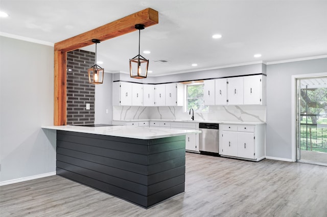 kitchen featuring a healthy amount of sunlight, kitchen peninsula, hanging light fixtures, stainless steel dishwasher, and white cabinetry