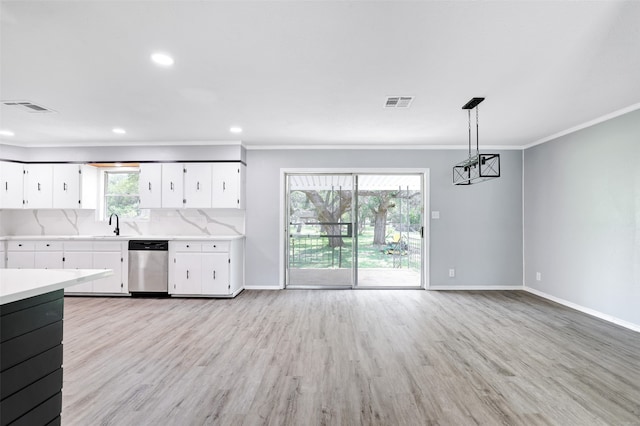 kitchen featuring dishwasher, hanging light fixtures, a healthy amount of sunlight, and white cabinets