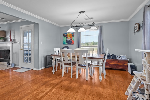 dining room featuring wood-type flooring and ornamental molding