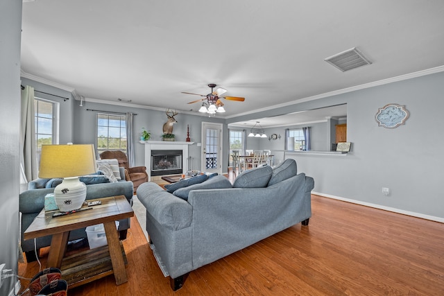 living room with ceiling fan, crown molding, and hardwood / wood-style floors