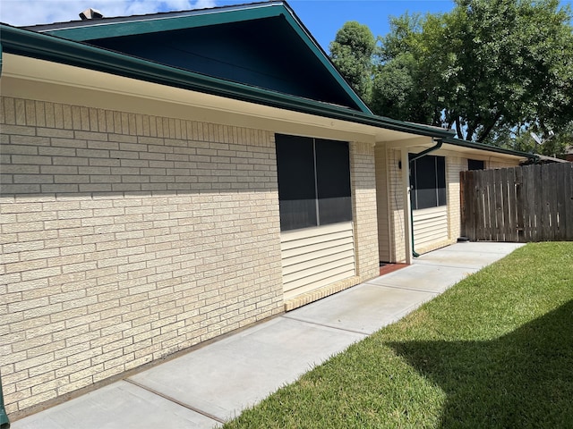 view of property exterior with a lawn