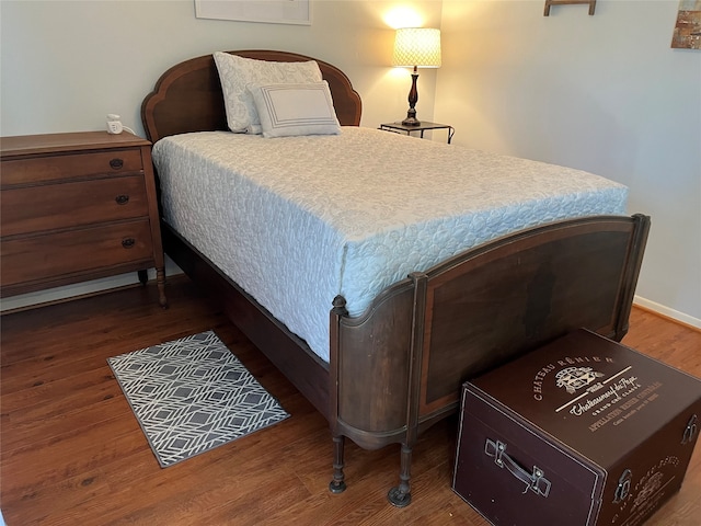 bedroom with dark hardwood / wood-style flooring