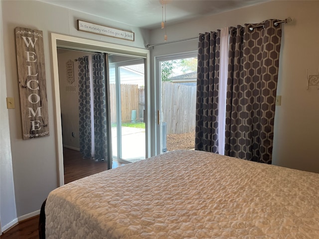 bedroom featuring access to outside and dark wood-type flooring