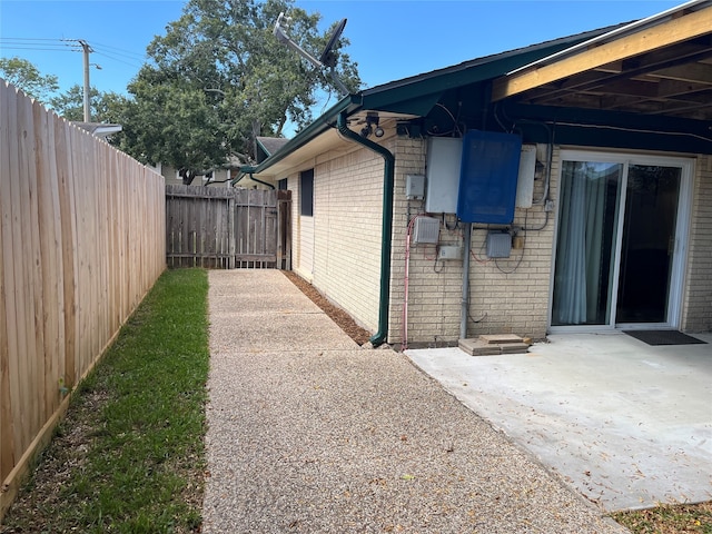 view of side of property with a patio