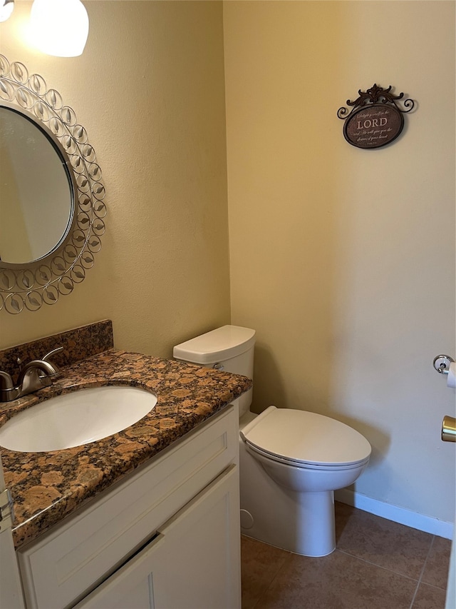 bathroom featuring vanity, toilet, and tile patterned floors