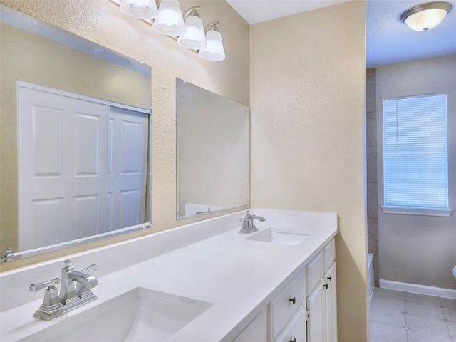 bathroom with vanity and tile patterned flooring