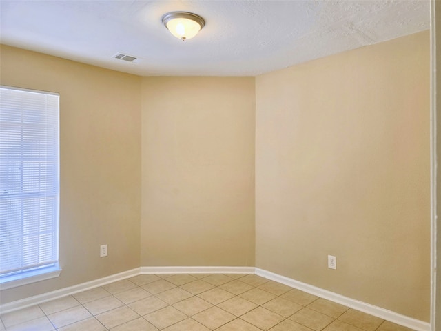 unfurnished room featuring light tile patterned floors