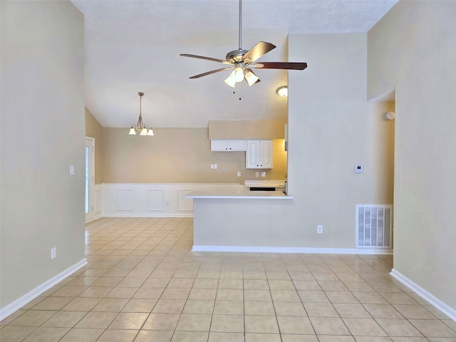 interior space with white cabinetry, high vaulted ceiling, and light tile patterned floors