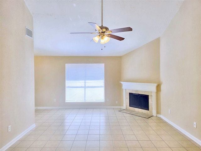 unfurnished living room featuring light tile patterned flooring, a tile fireplace, and ceiling fan