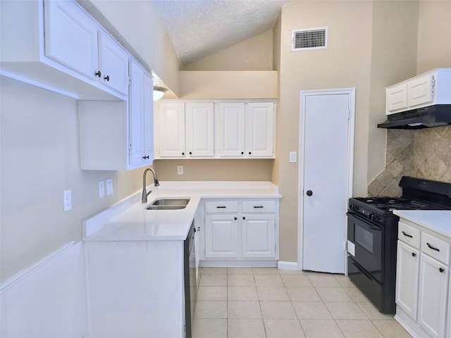 kitchen with lofted ceiling, black gas stove, sink, white cabinets, and a textured ceiling