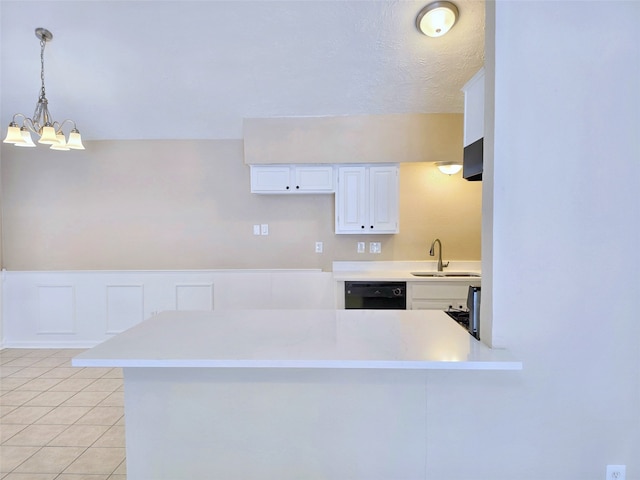 kitchen with kitchen peninsula, white cabinets, black dishwasher, hanging light fixtures, and sink