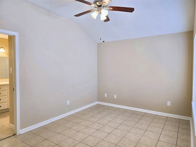 tiled empty room with vaulted ceiling and ceiling fan