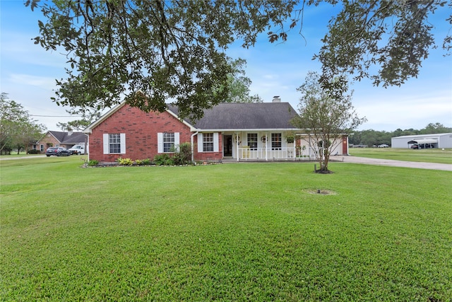 view of front of house with a front yard and a porch