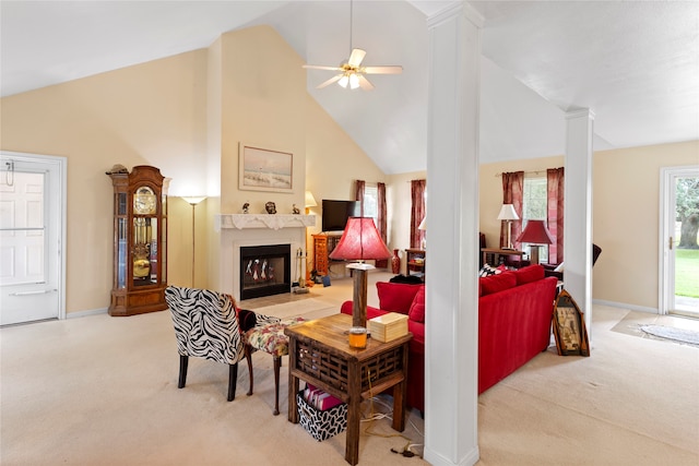 living room featuring light carpet, ornate columns, high vaulted ceiling, and ceiling fan