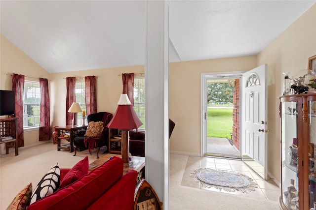 entrance foyer with light tile patterned floors, vaulted ceiling, and a wealth of natural light