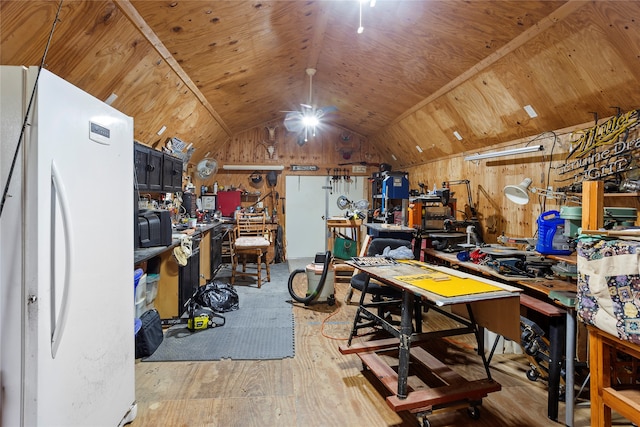 interior space featuring wood-type flooring, a workshop area, lofted ceiling, and wooden walls