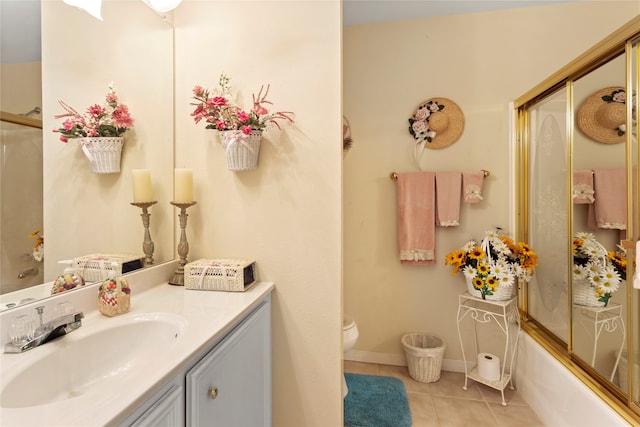 full bathroom with vanity, combined bath / shower with glass door, toilet, and tile patterned flooring