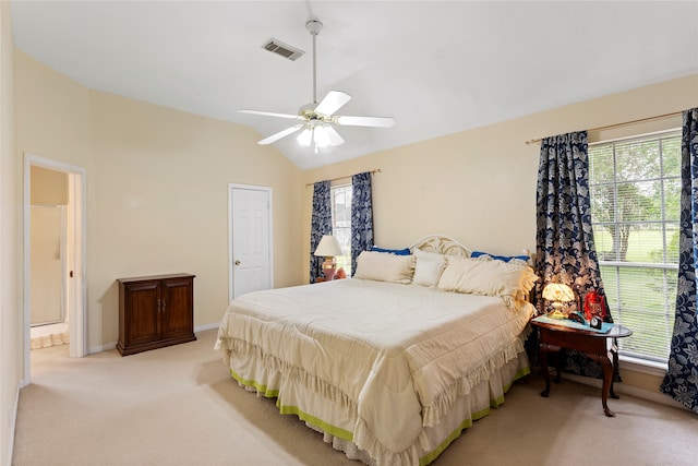 bedroom featuring lofted ceiling, light carpet, and ceiling fan