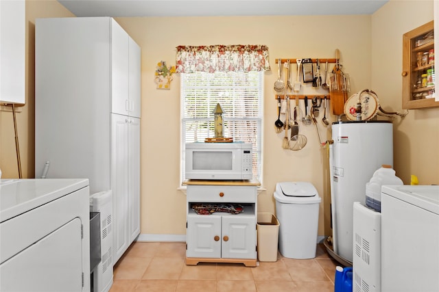 washroom with washer / clothes dryer, water heater, and light tile patterned flooring