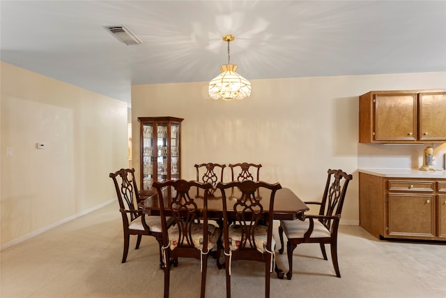 dining room with light colored carpet