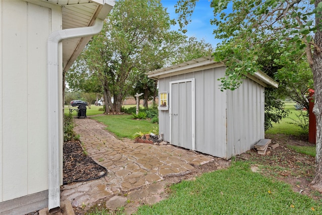 view of outbuilding featuring a lawn