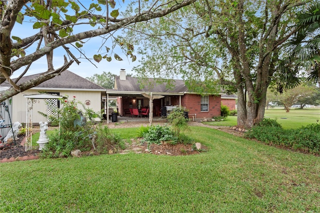 back of property featuring a patio area and a yard