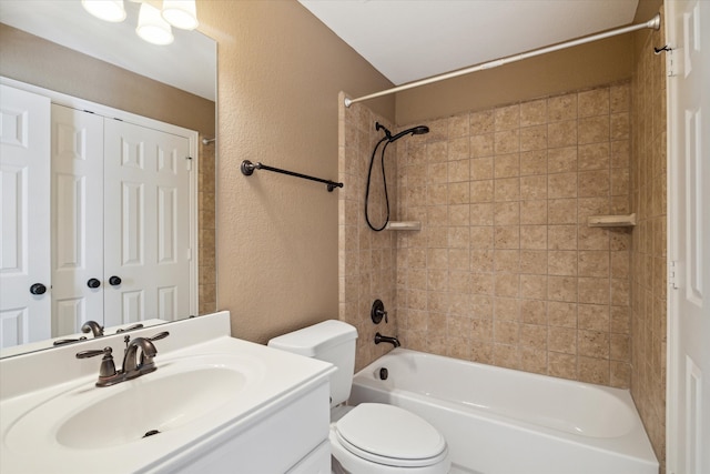 full bathroom with vanity, toilet, and tiled shower / bath