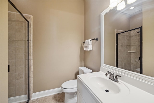 bathroom with tile patterned flooring, vanity, toilet, and walk in shower