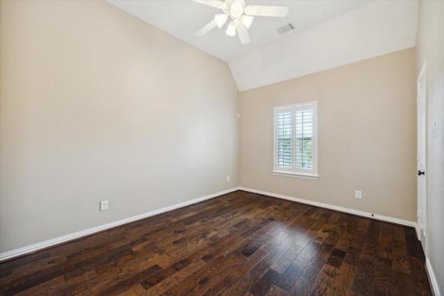 spare room featuring ceiling fan, dark hardwood / wood-style flooring, and vaulted ceiling