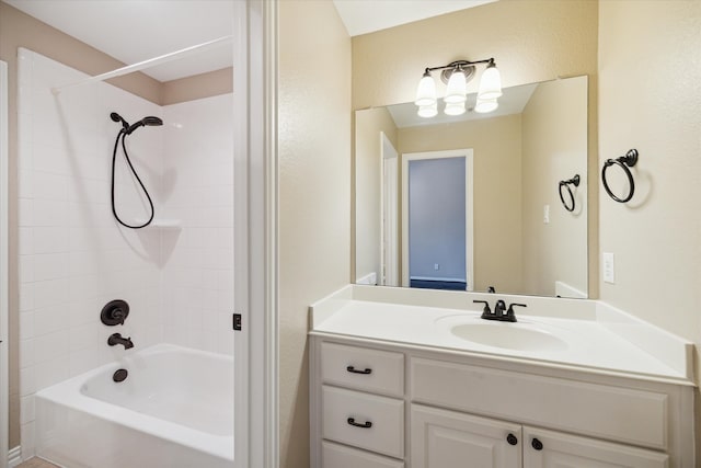 bathroom featuring vanity and tiled shower / bath