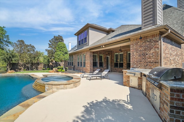 view of swimming pool with ceiling fan, an in ground hot tub, area for grilling, exterior kitchen, and a patio