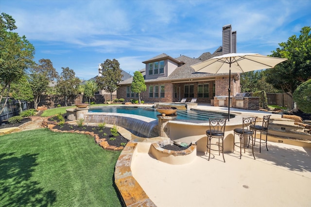 view of swimming pool featuring a bar, a patio area, and a lawn