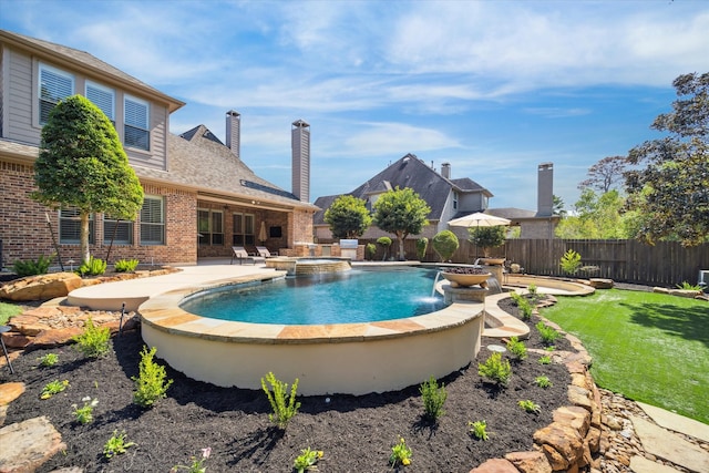 view of swimming pool with an in ground hot tub, a yard, pool water feature, and a patio