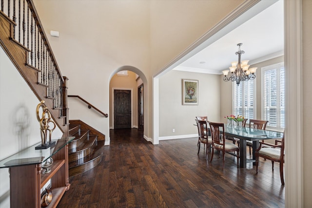 dining area featuring a chandelier, dark hardwood / wood-style floors, and ornamental molding