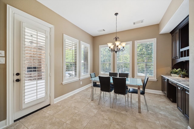 tiled dining area featuring a notable chandelier