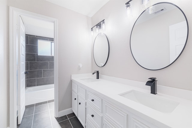 bathroom featuring vanity, tile patterned floors, and tiled shower / bath