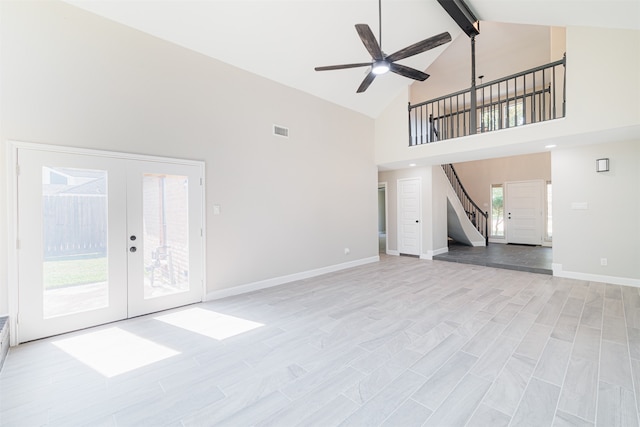 unfurnished living room featuring french doors, high vaulted ceiling, beamed ceiling, and light hardwood / wood-style flooring