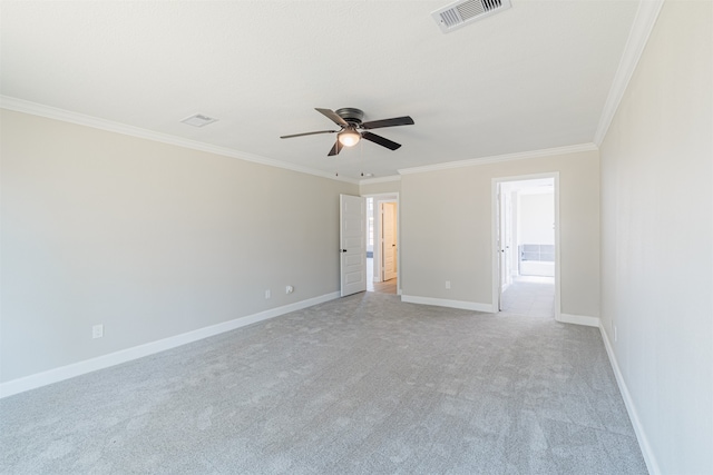 spare room featuring crown molding, light colored carpet, and ceiling fan