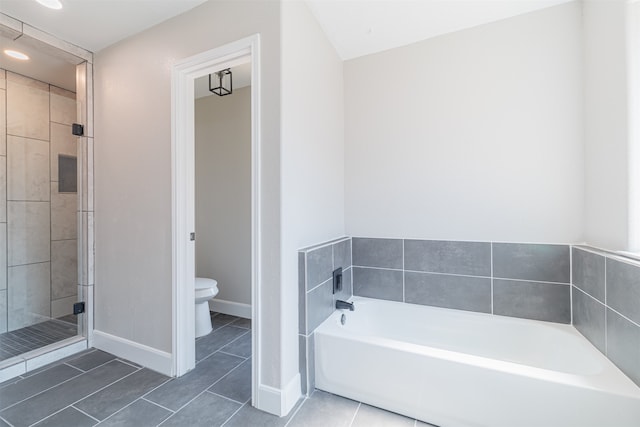 bathroom featuring plus walk in shower, toilet, and tile patterned flooring