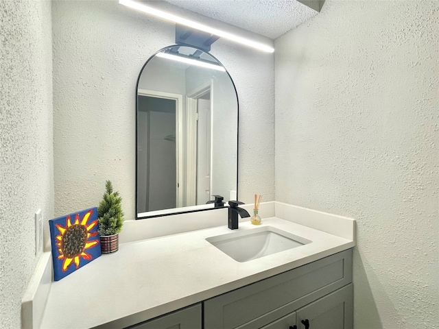 bathroom with vanity and a textured ceiling