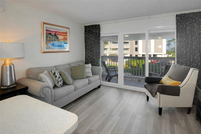 6102 Seawall Blvd Unit 161, Galveston, TX 77551 - living area featuring crown molding, wood finished floors, and a textured ceiling