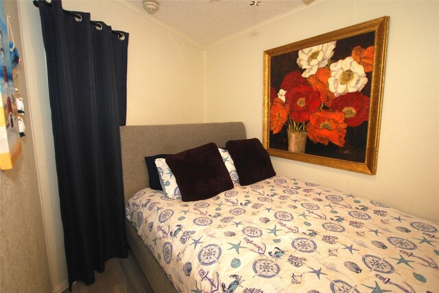 6102 Seawall Blvd Unit 161, Galveston, TX 77551 - bedroom featuring crown molding and a textured ceiling