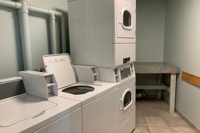 6102 Seawall Blvd Unit 161, Galveston, TX 77551 - community laundry with stacked washer / drying machine, baseboards, and washing machine and dryer
