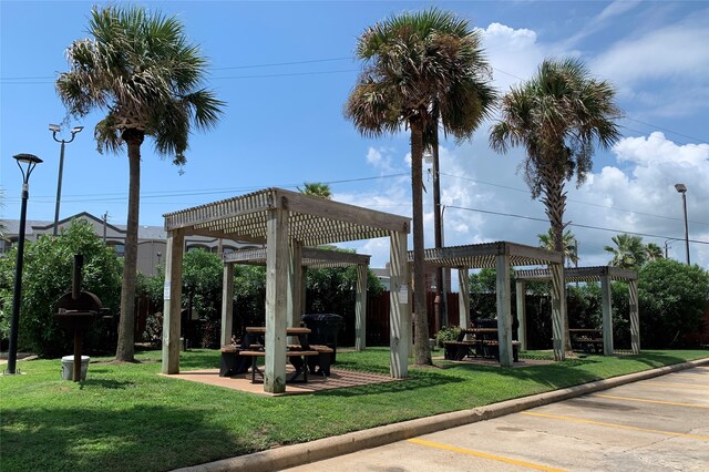 6102 Seawall Blvd Unit 161, Galveston, TX 77551 - view of home's community with a pergola, a yard, and uncovered parking