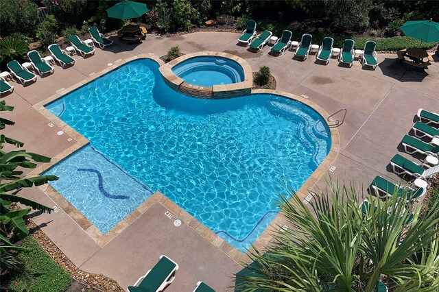 6102 Seawall Blvd Unit 161, Galveston, TX 77551 - view of pool featuring a pool with connected hot tub and a patio
