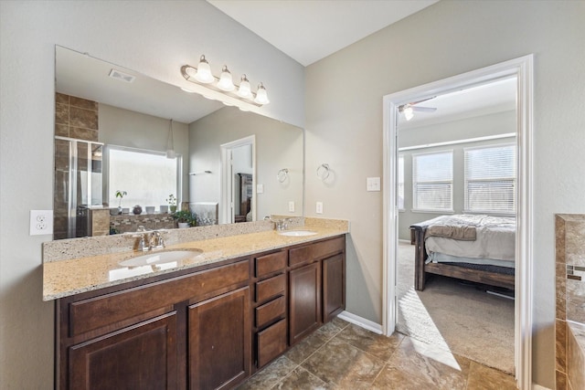 bathroom featuring ceiling fan, vanity, and walk in shower