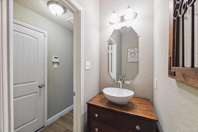 bathroom with vanity and wood-type flooring